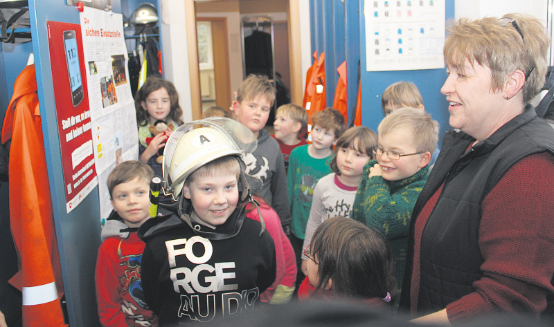 Spaß im Gerätehaus: Die Teilnehmer an der Feuerwehr-AG von Dina Reichstein (rechts) schauen sich im Umkleideraum der Freiwilligen Feuerwehr Düshorn um.