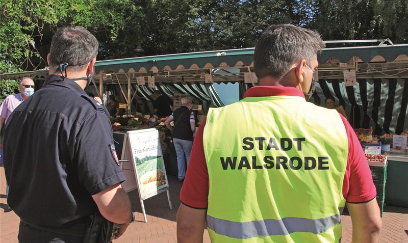 Deutlich erkennbar mit Uniform und Warnweste gehen Thomas Bröckel (links) und Kai Thomas Kunert über den Walsroder Wochenmarkt. Foto: Langemeyer