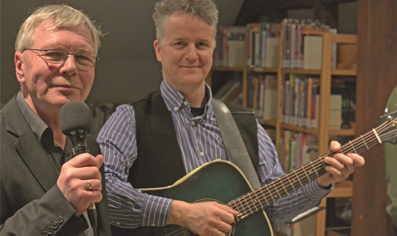 Musik und Literatur: Heinrich Thies (links) stellt sein neues Buch vor, Johnny Groffmann spielt dazu Lieder. Foto: Veranstalter